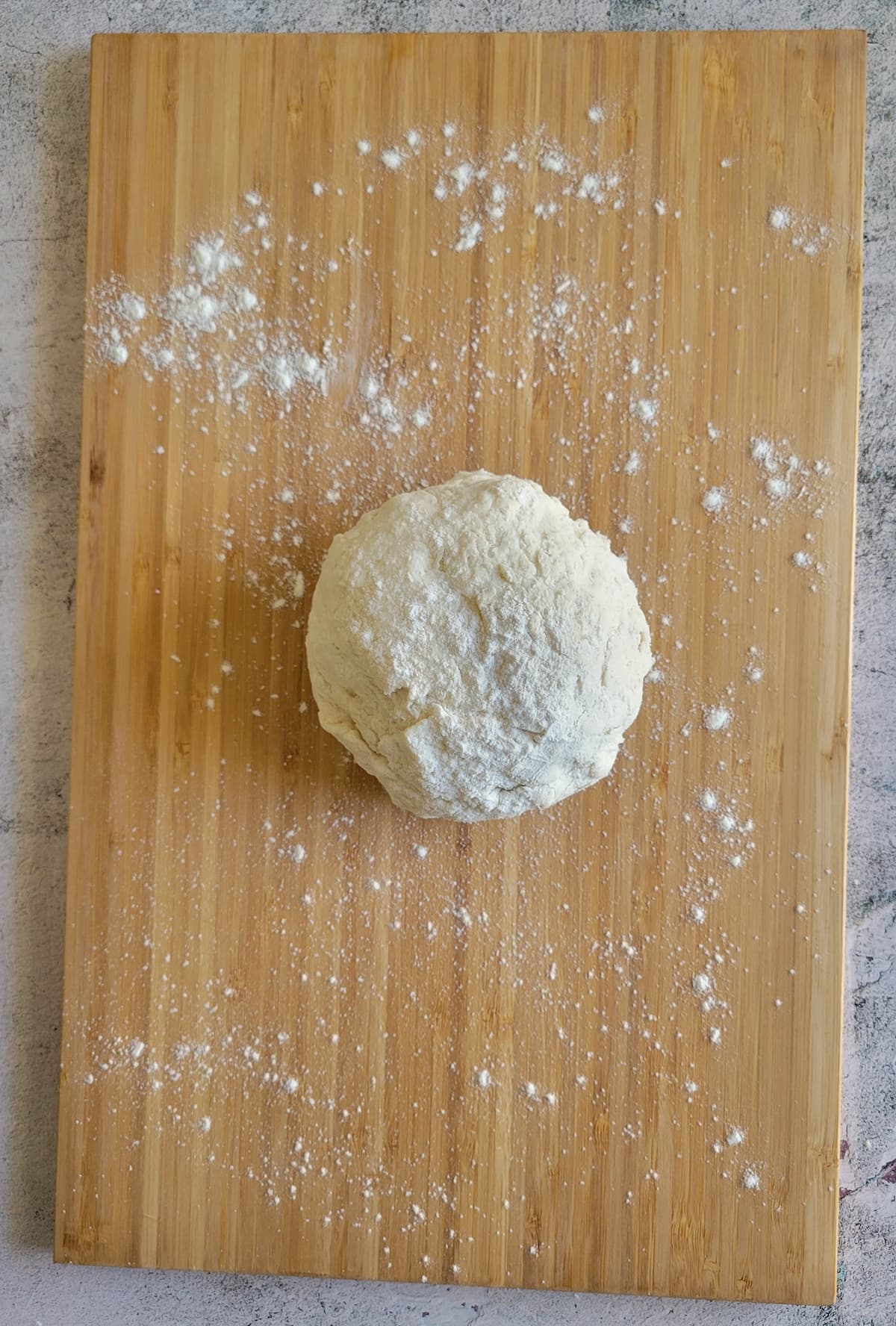 ball of dough on a floured cutting board