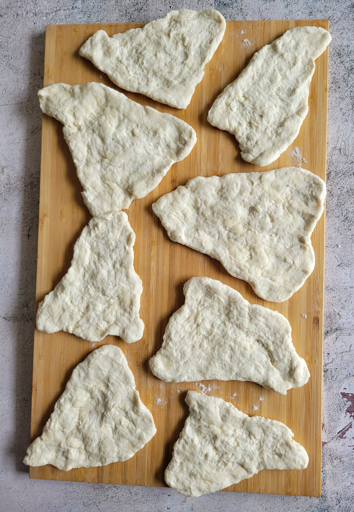 triangular pieces of dough on a cutting board