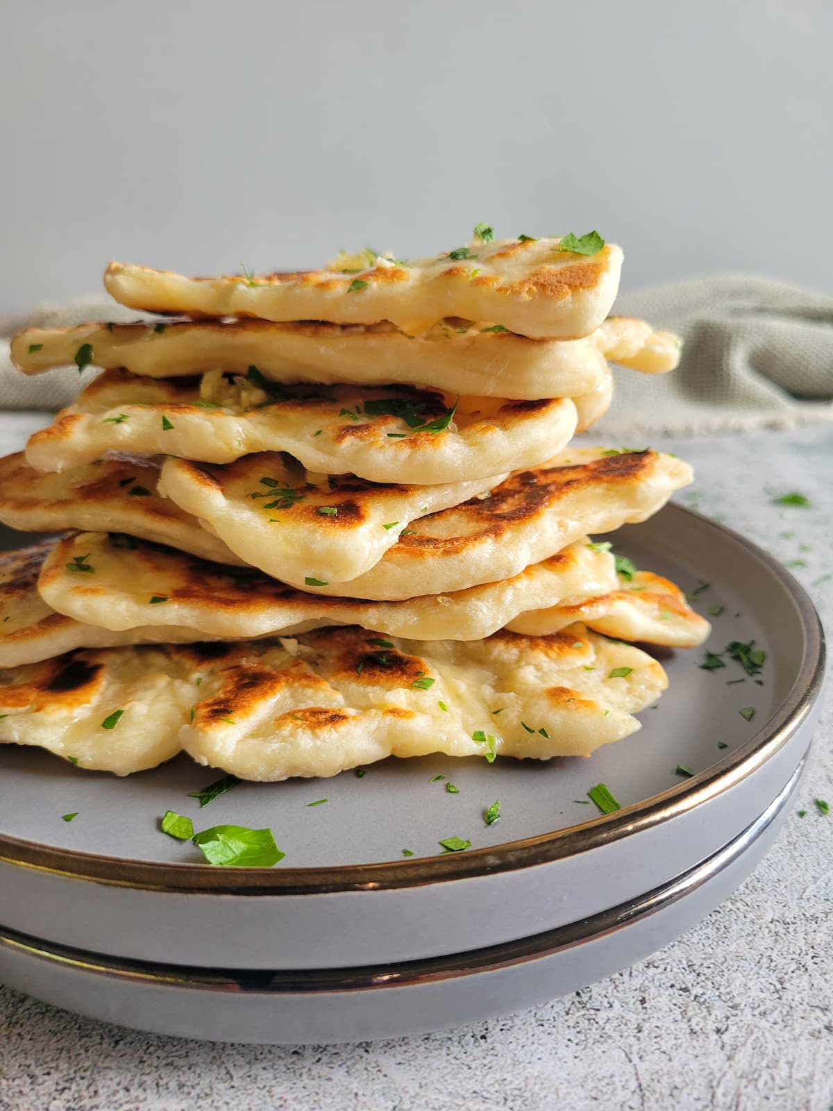 garlic naan bread piled on double plates