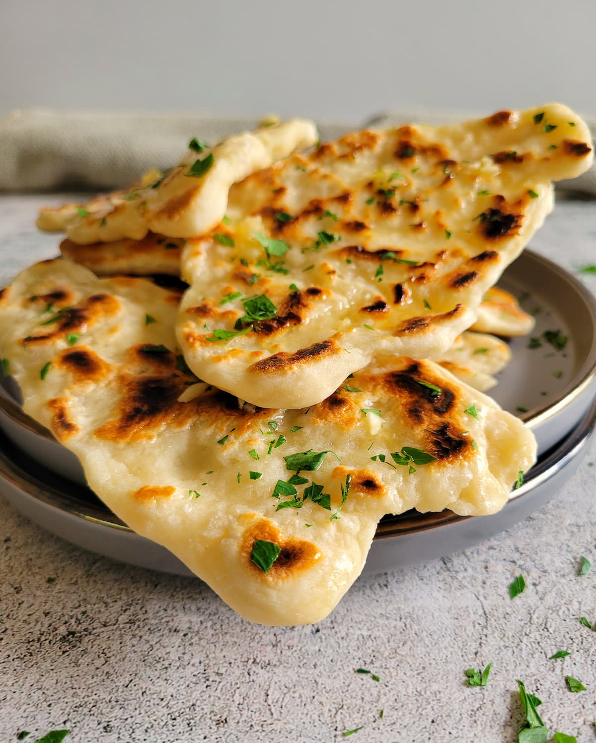 garlic naan bread piled on double plates