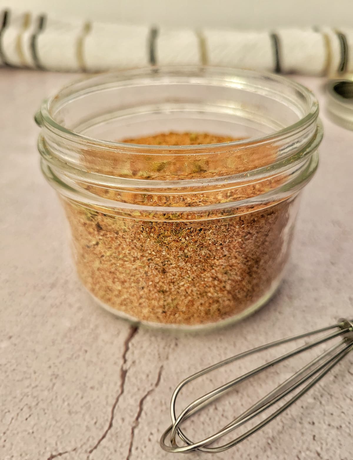 spice blend in a jar with a small whisk in front