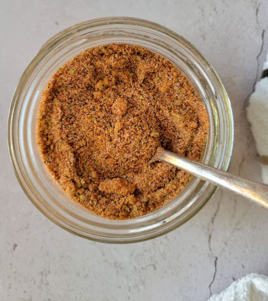 brisket rub in a jar with a spoon in it