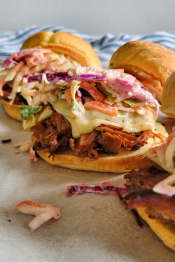 3 brisket sandwiches with cheese and coleslaw