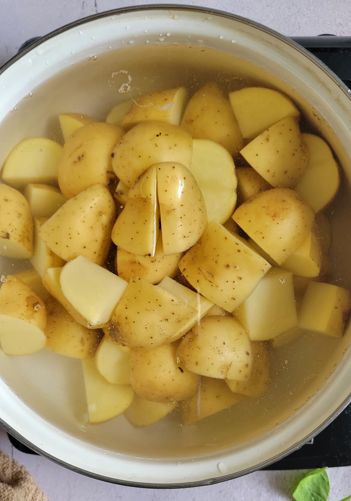cubed white potatoes in a pot of water