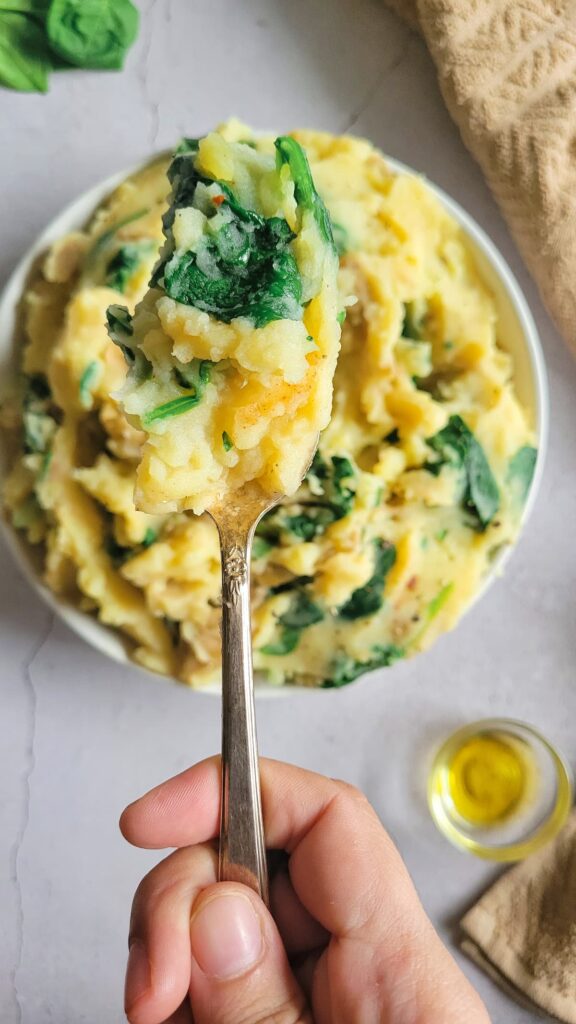 spoonful of mashed potatoes and spinach over a bowl of the rest