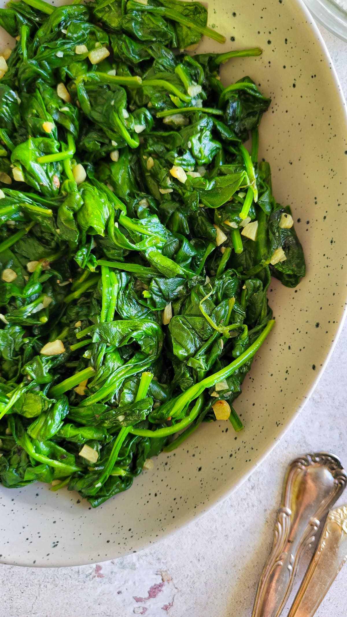 bowl of sauteed spinach and minced garlic