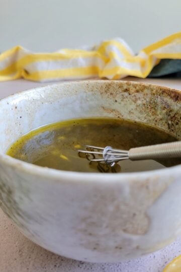 poppy seed dressing in a bowl with a whisk
