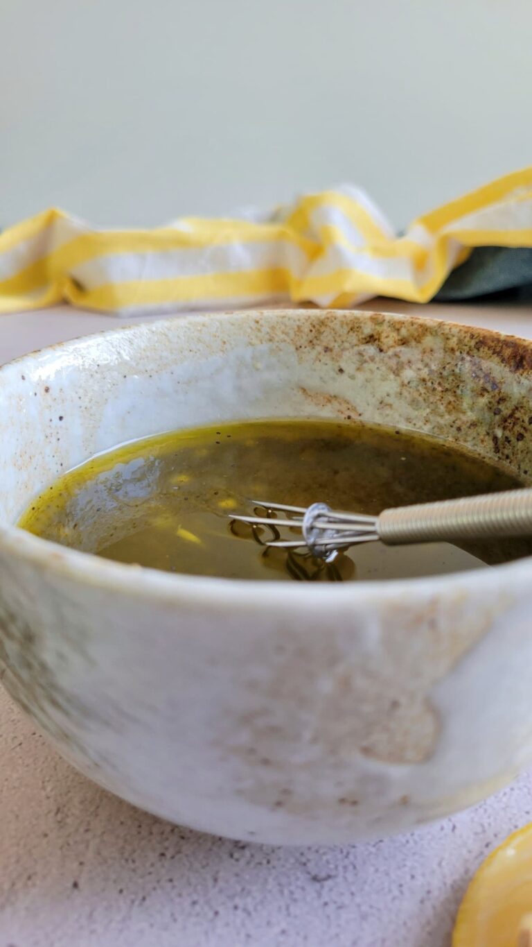 poppy seed dressing in a bowl with a whisk