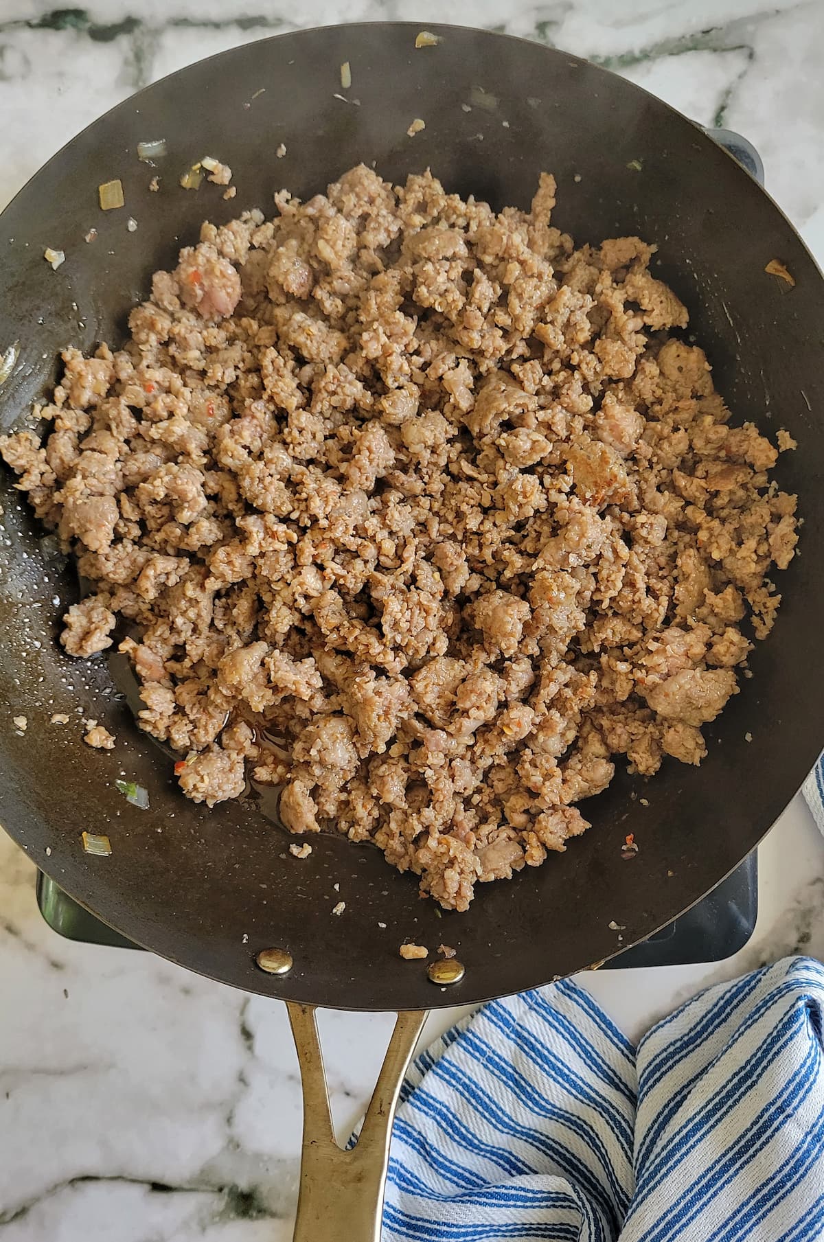 cooked ground italian sausage in a skillet
