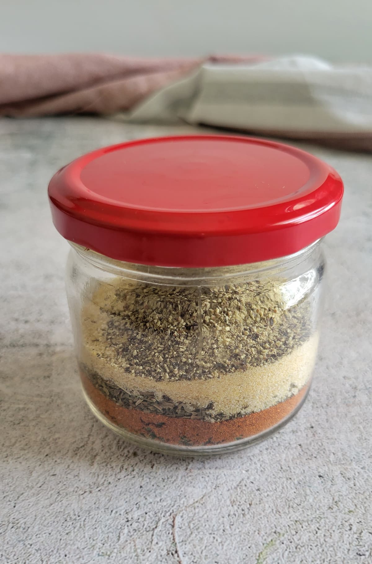 layered spices in a jar with a lid