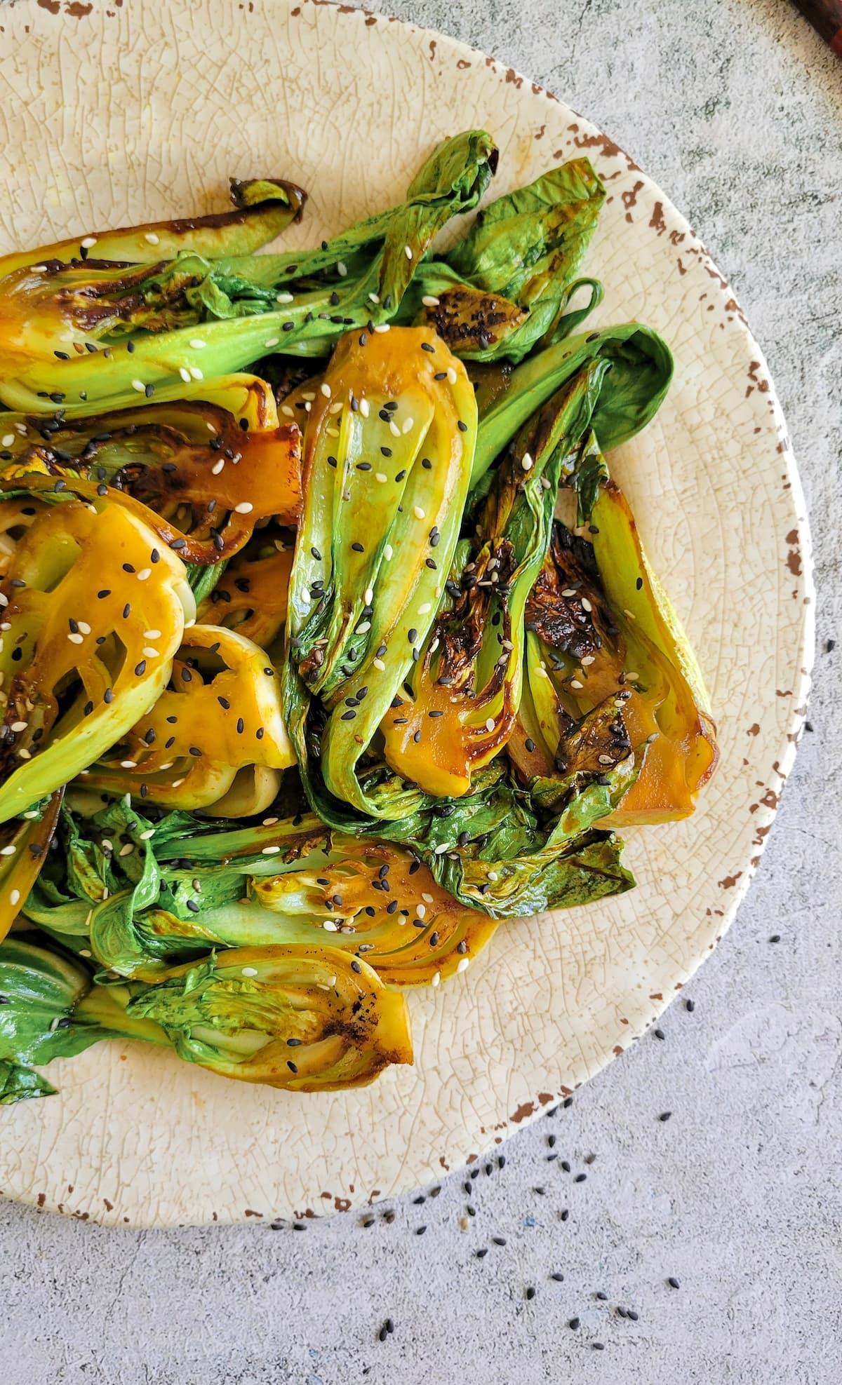caramelized bok choy on a plate with sesame seeds