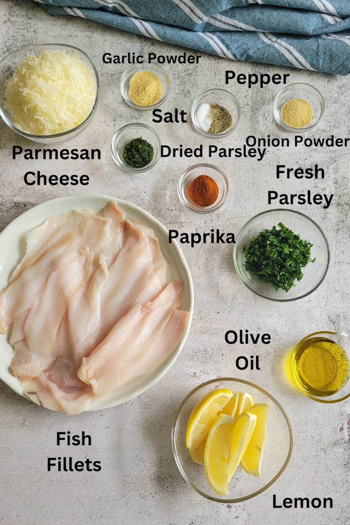 ingredient list for crusted parmesan fish - fish fillets, olive oil, lemon, dried and fresh parsley, parmesan cheese, garlic powder, onion powder, paprika, salt and pepper