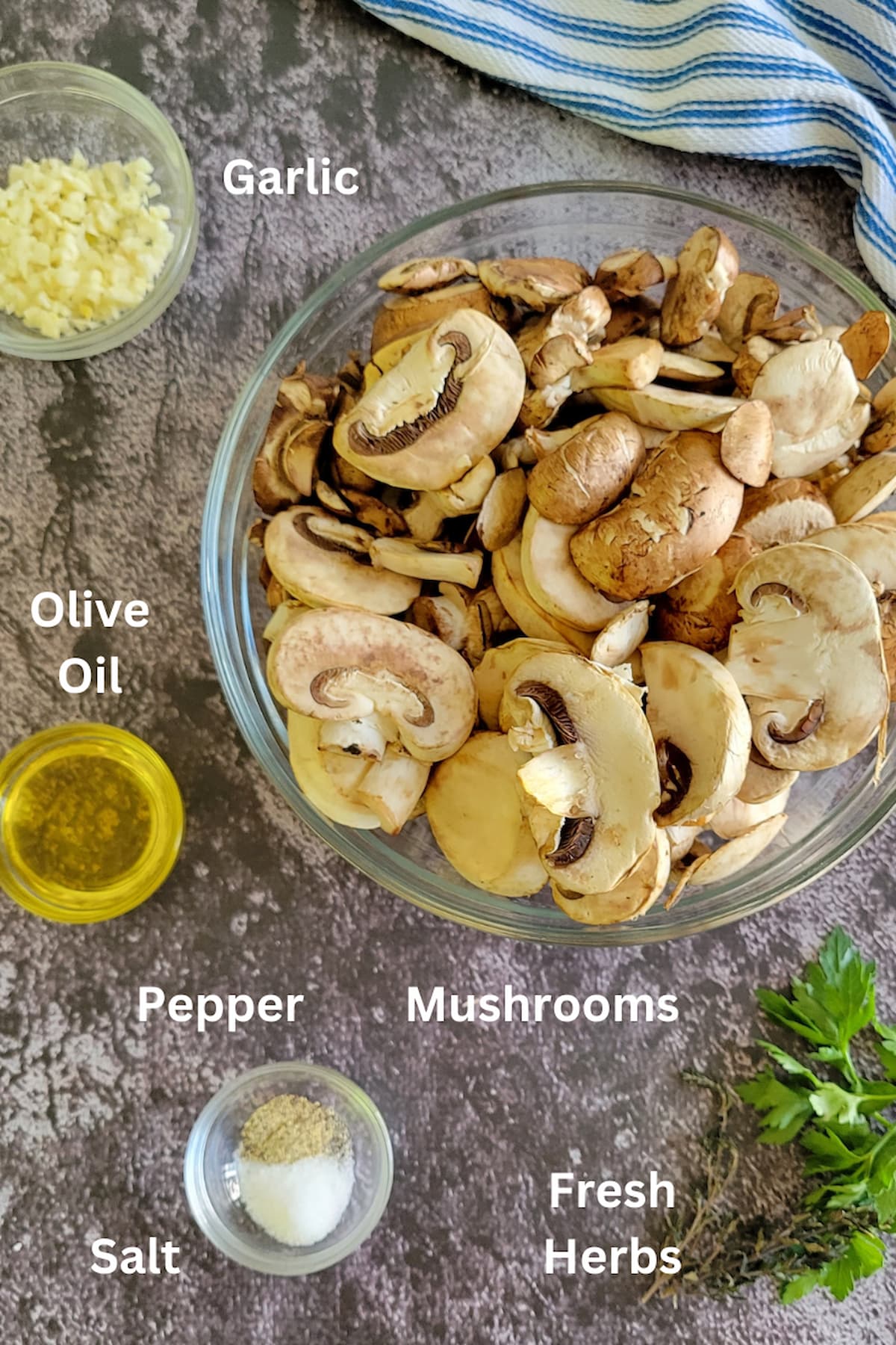 ingredients for sauteed mushrooms - mushrooms, garlic, salt, pepper, olive oil, fresh herbs