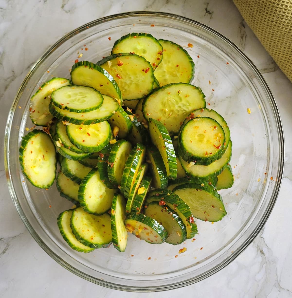 sliced cucumber in a bowl with spices