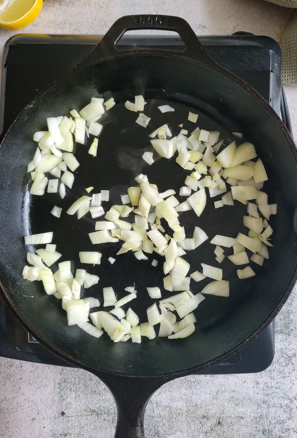 diced white onions in a cast iron skillet