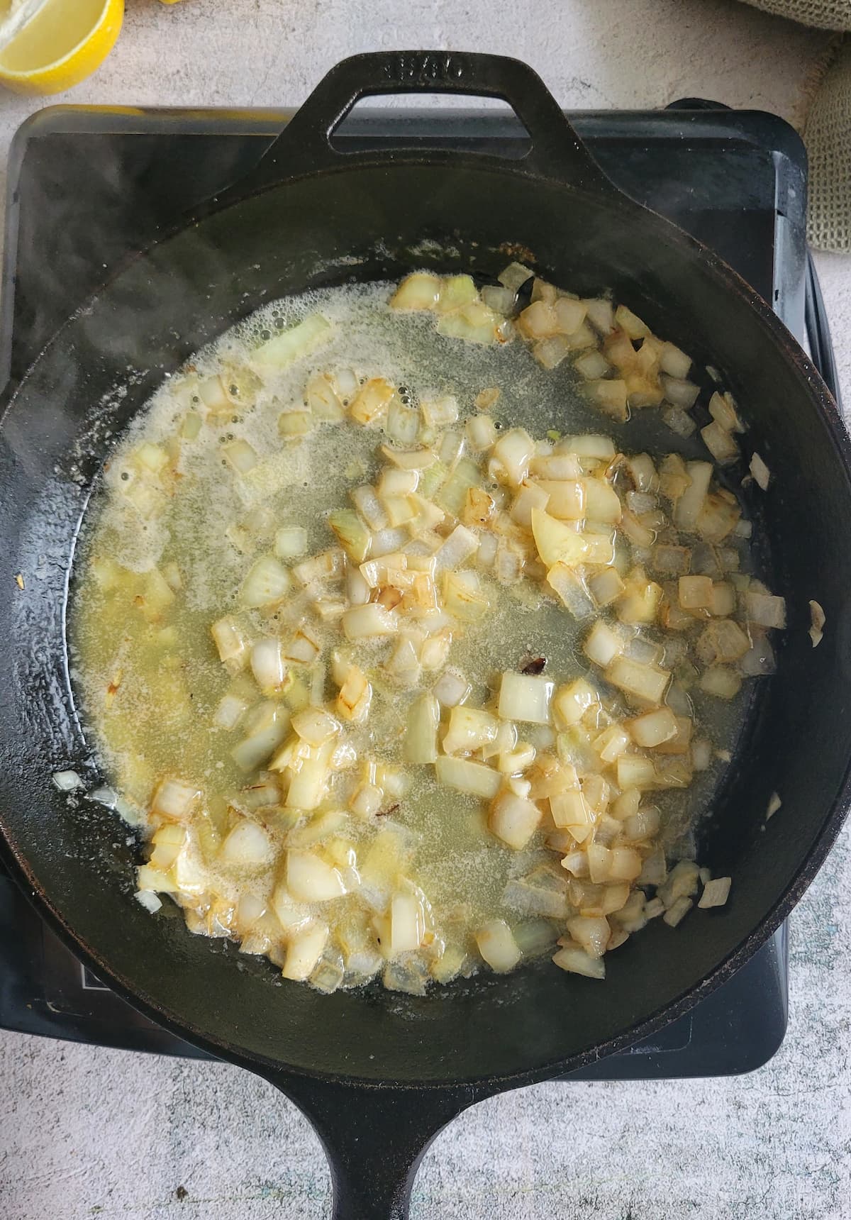melted butter and diced onions in a cast iron skillet
