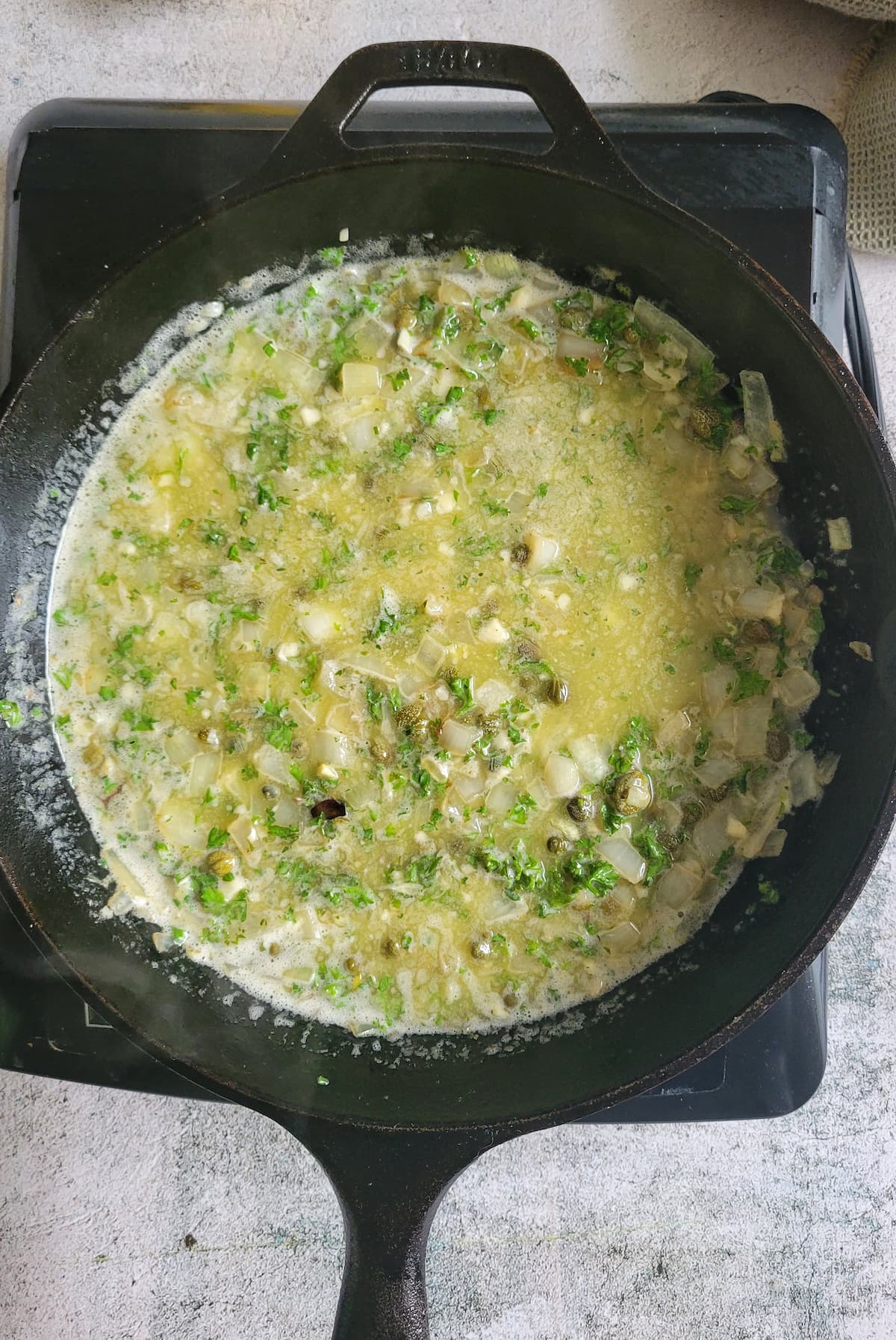 butter, parsley, capers and onions in melted butter