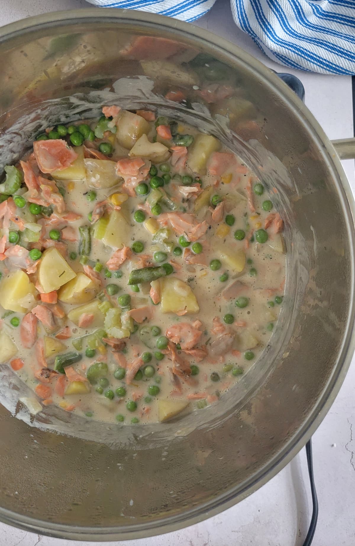 chunks of salmon, cheese, potatoes and cream in a pot