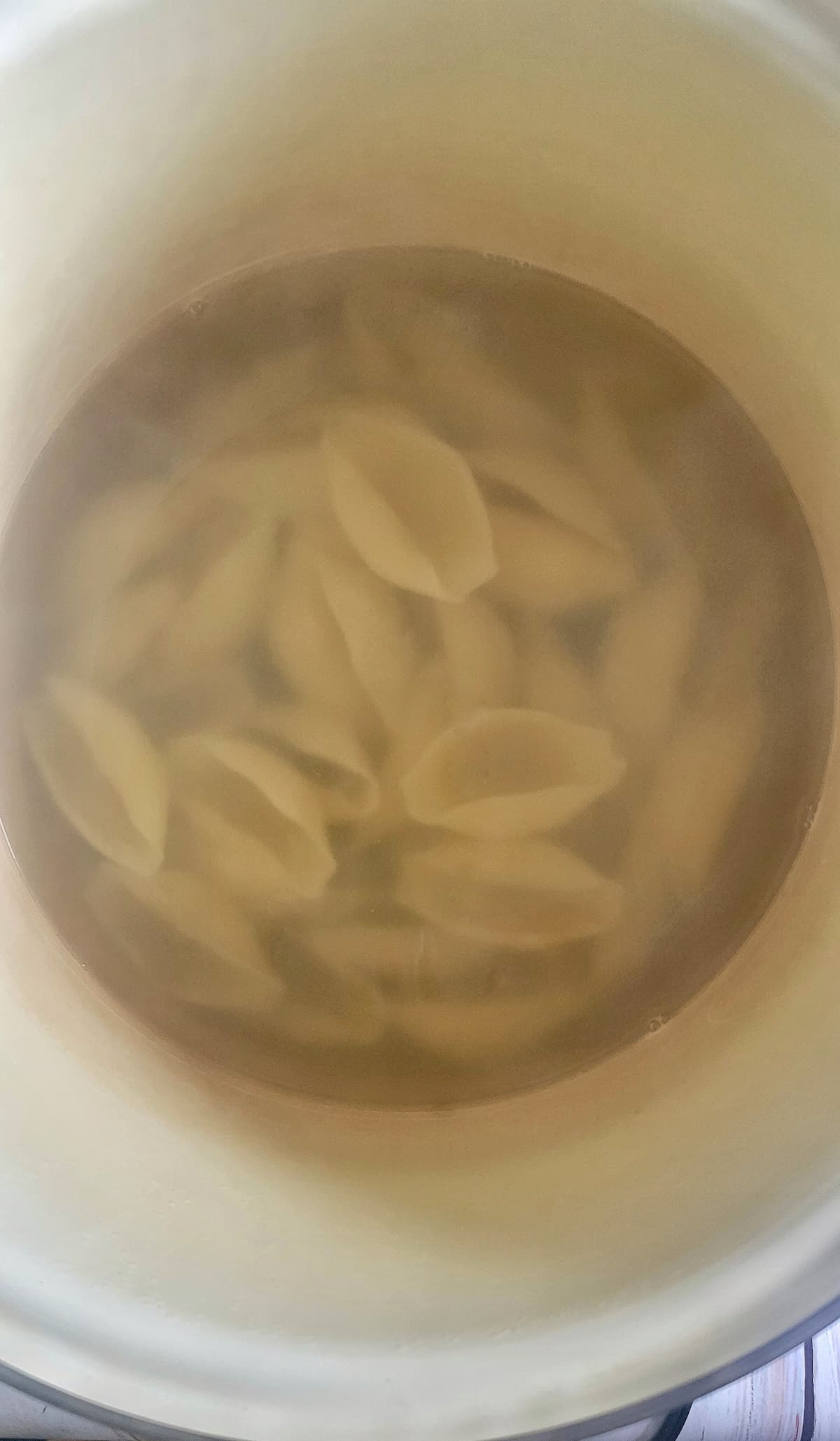 pasta shells cooking in a pot of water