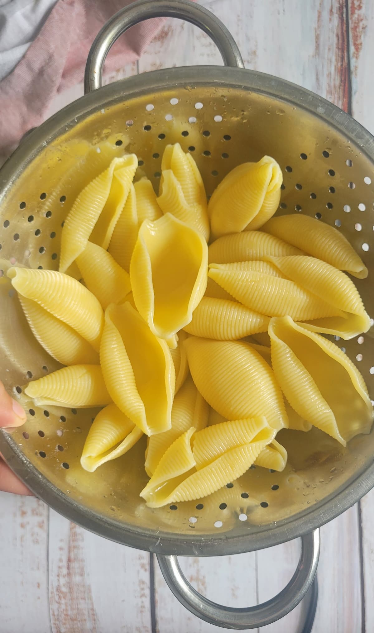 cook pasta shells in a colander
