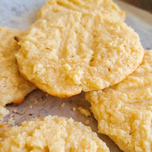5 cookies layered on a parchment lined baking sheet