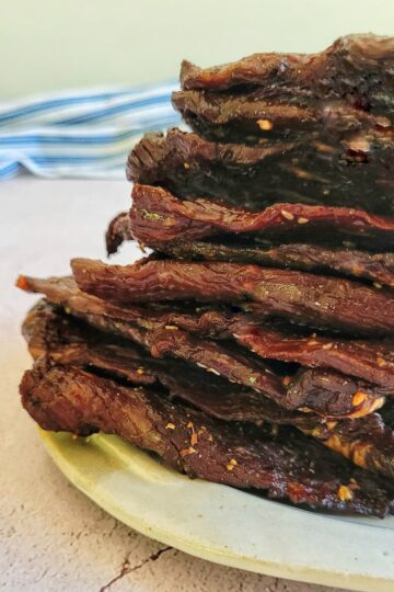 slices of beef jerky stacked on a plate