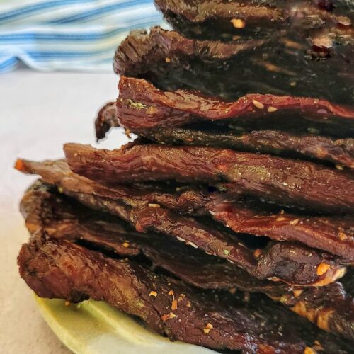 slices of beef jerky stacked on a plate