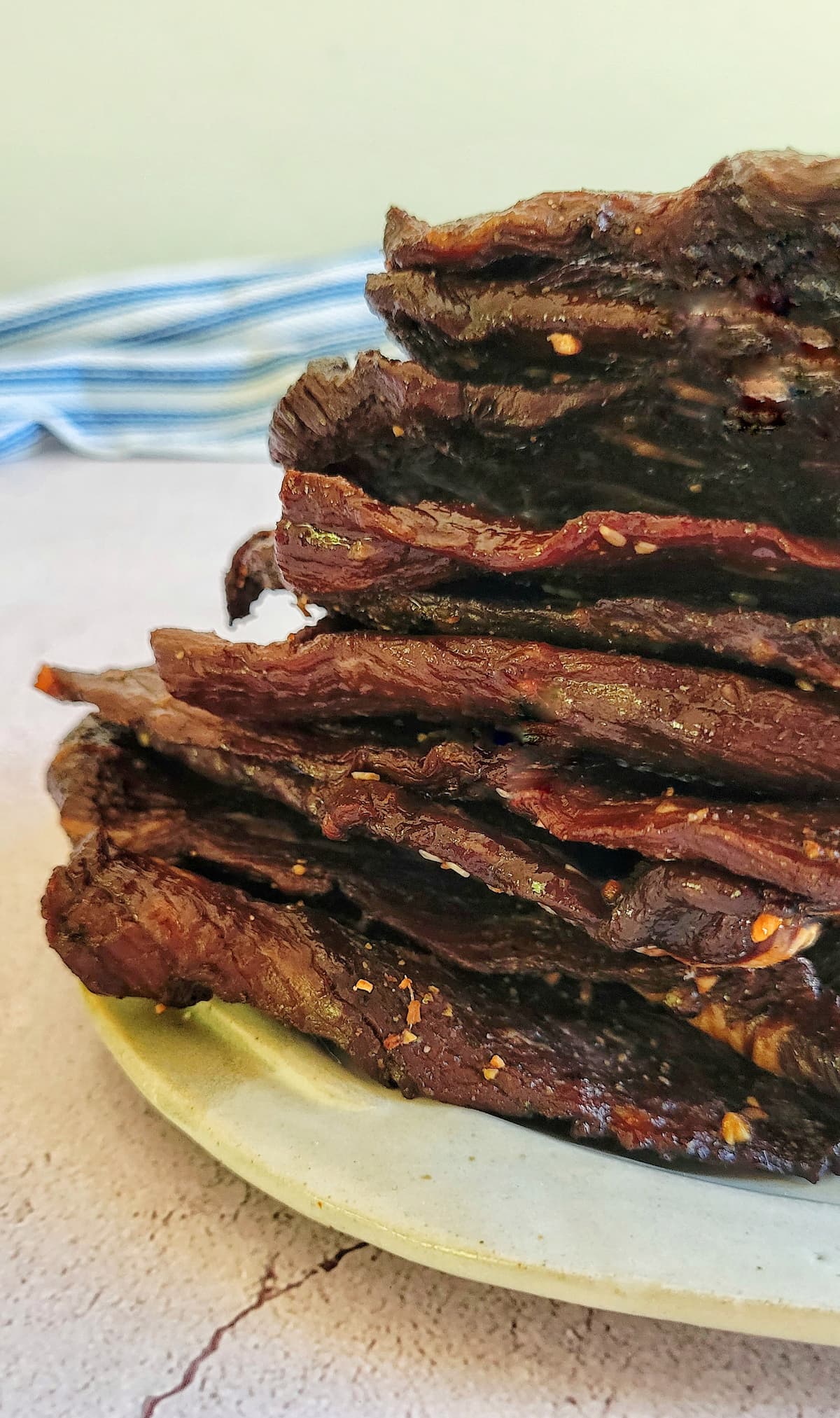 slices of beef jerky stacked on a plate
