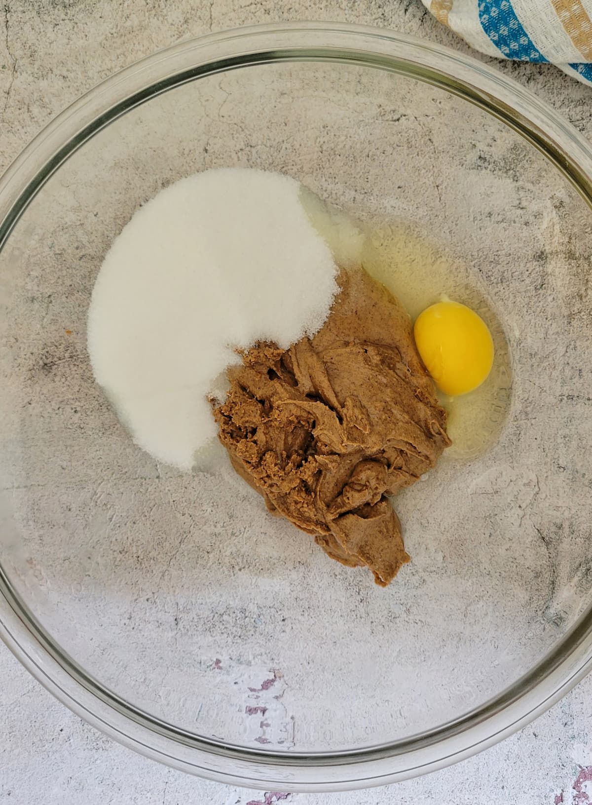 sweetener, almond butter and an egg in a bowl