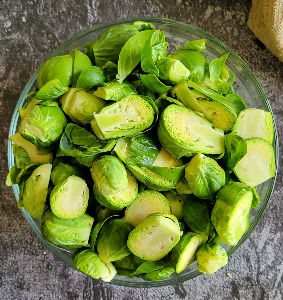 halved and trimmed raw brussels sprouts in a bowl