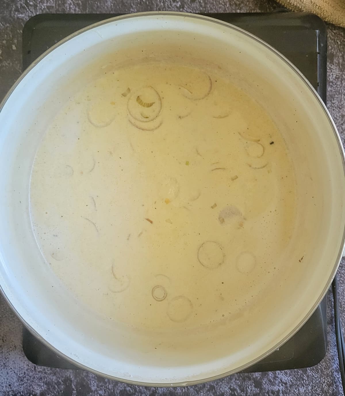 shallots and cream sauce in a pot