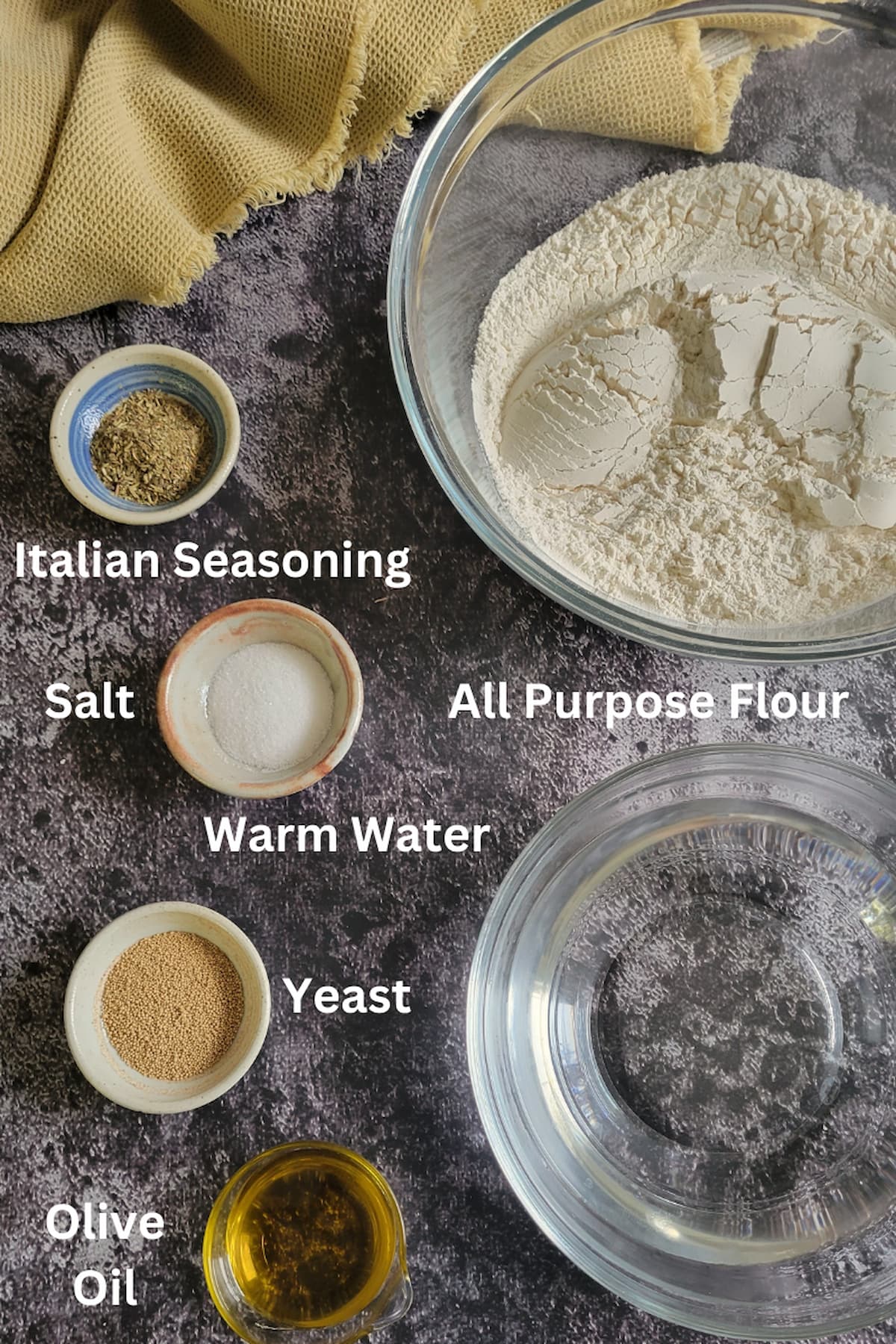ingredients for how to make homemade dough for pizzas - all purpose flour, warm water, yeast, salt, italian seasoning, olive oil