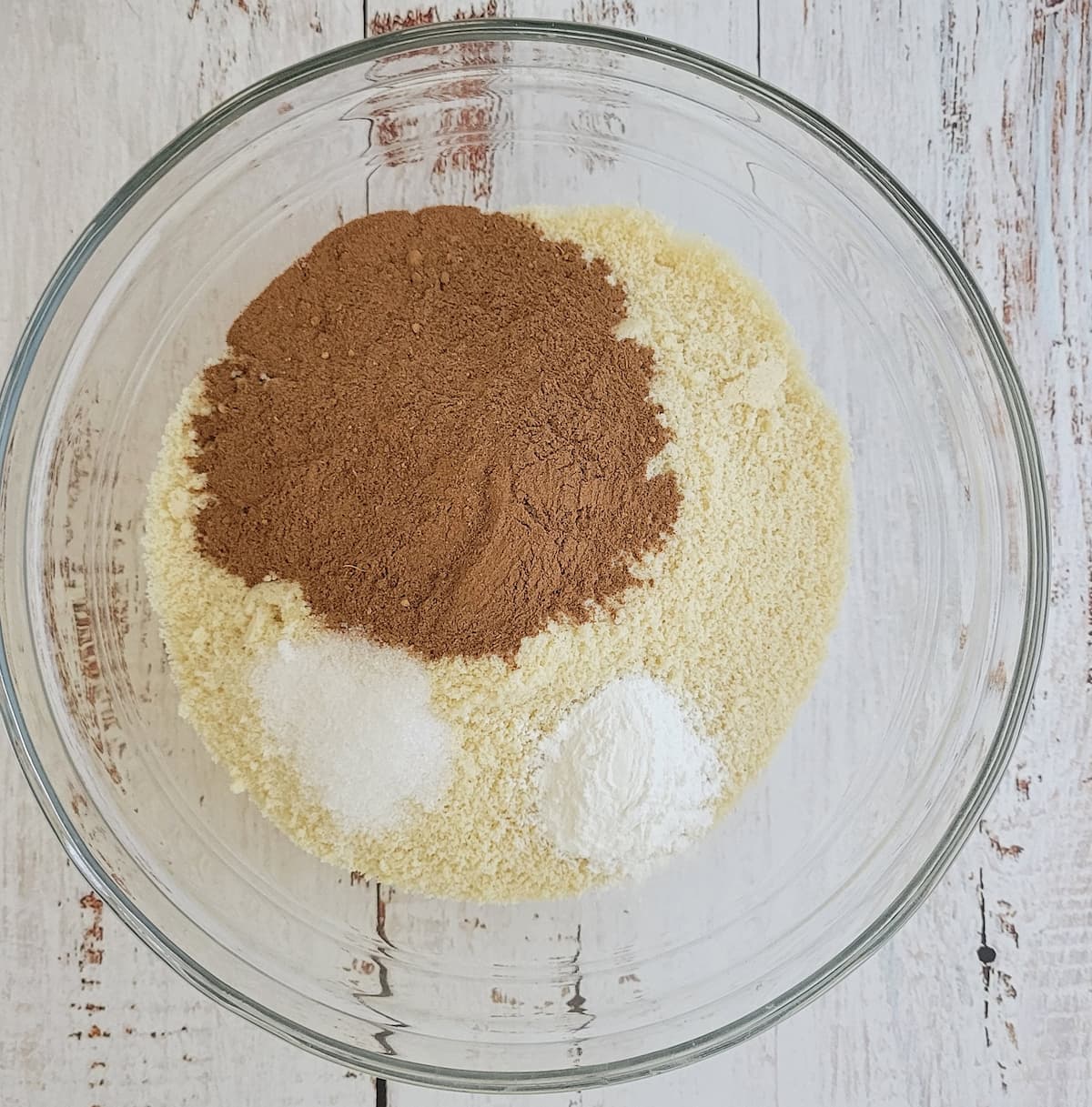 almond flour, cocoa powder, salt and baking powder unmixed in a bowl