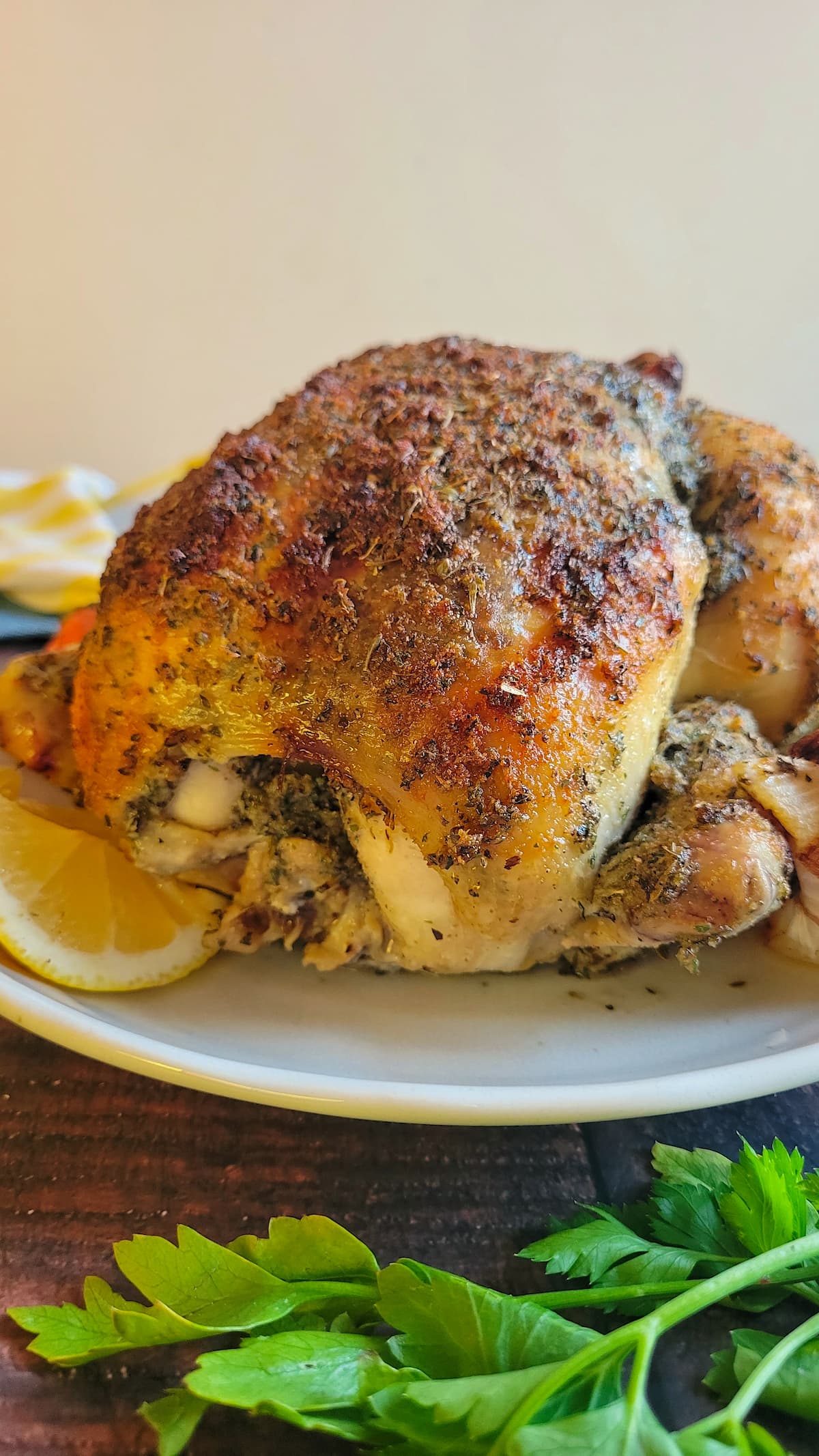 whole cooked chicken on a plate with lemon