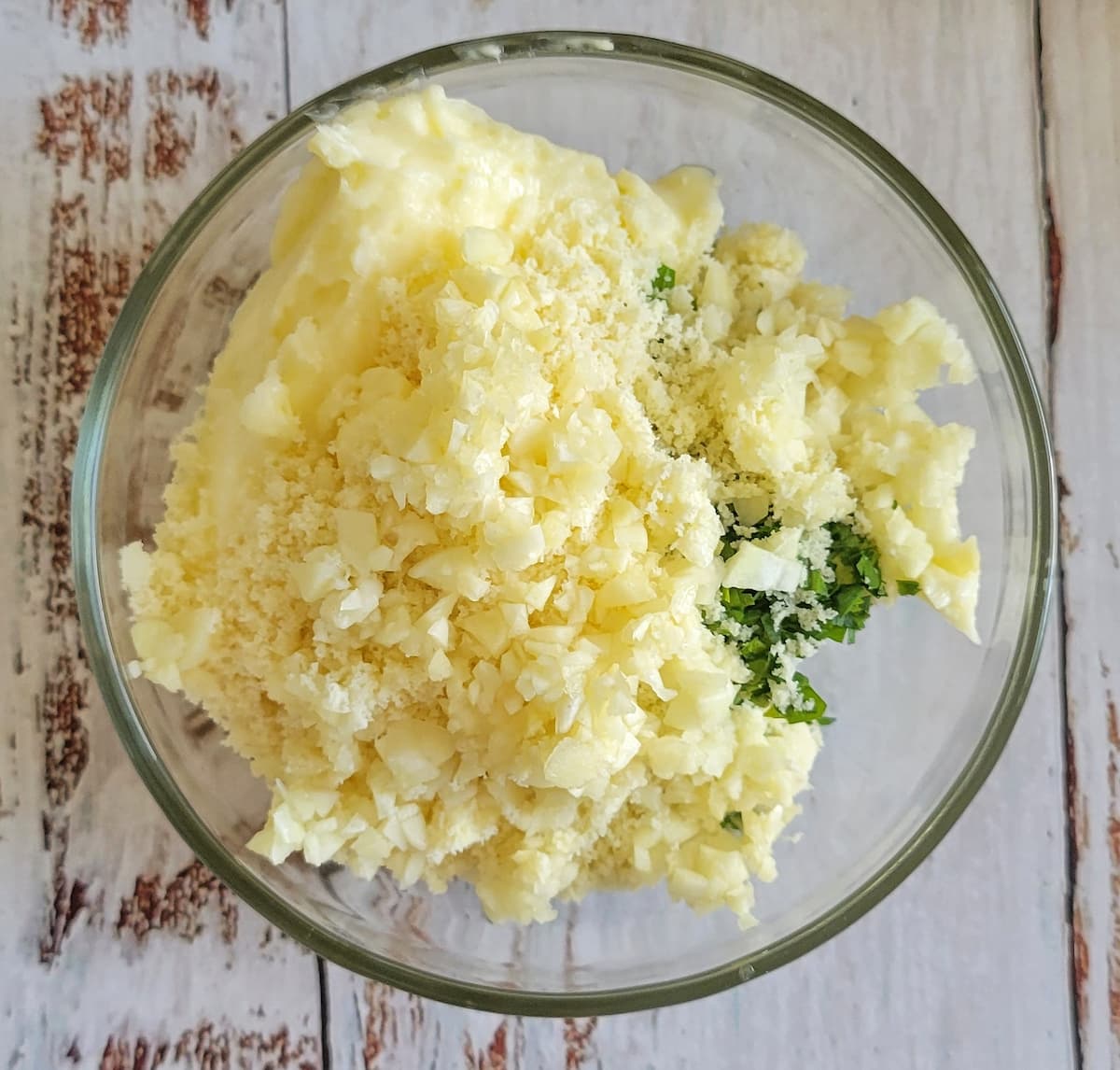 garlic, butter, parmesan cheese and herbs unmixed in a bowl