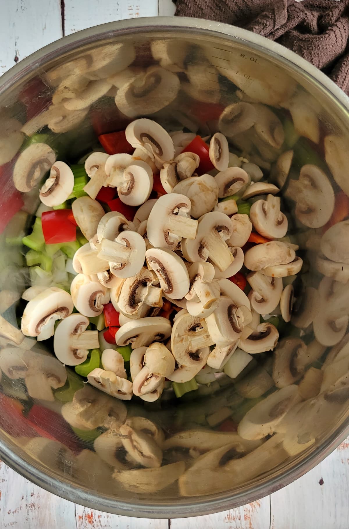 sliced mushrooms and other veggies in a pot