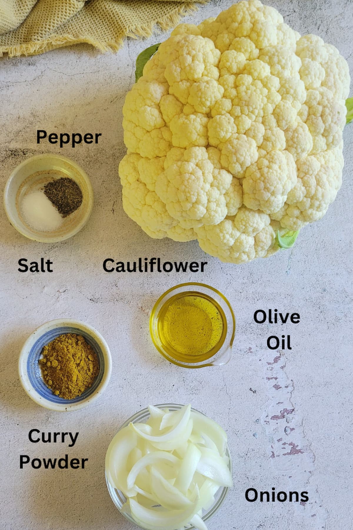 ingredients for cauliflower with curry - cauliflower, onions, curry powder, olive oil, salt and pepper