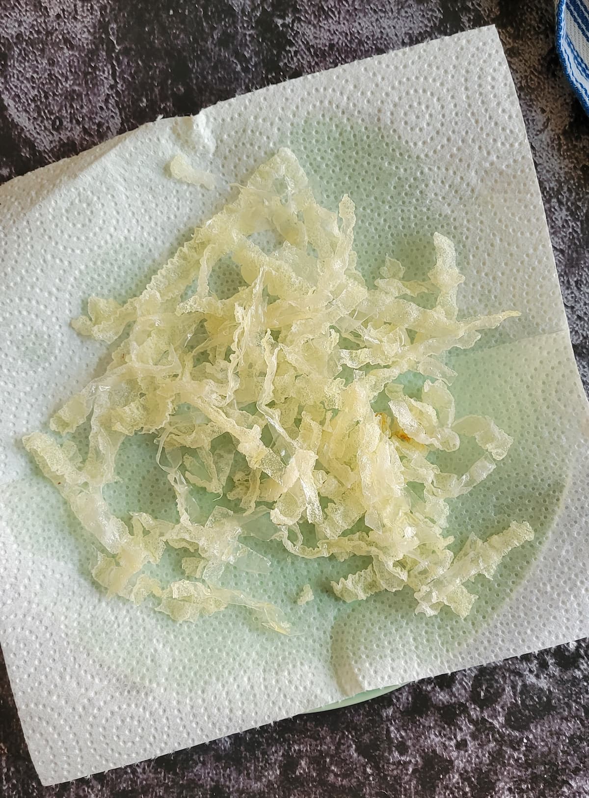 fried rice paper strips on a paper towel lined plate