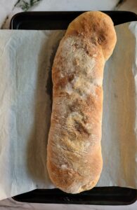 baked swiss chard roll on a parchment lined baking sheet
