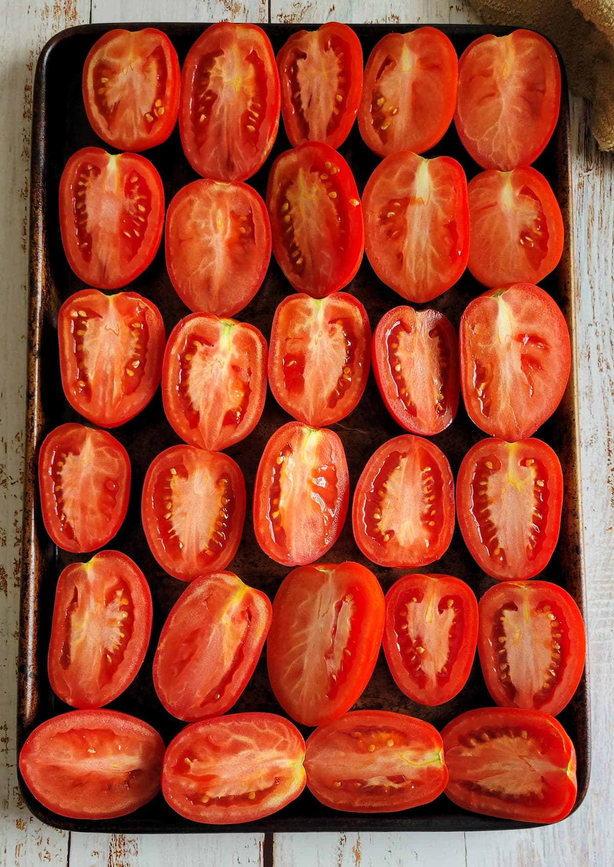halved tomatoes on a sheet pan