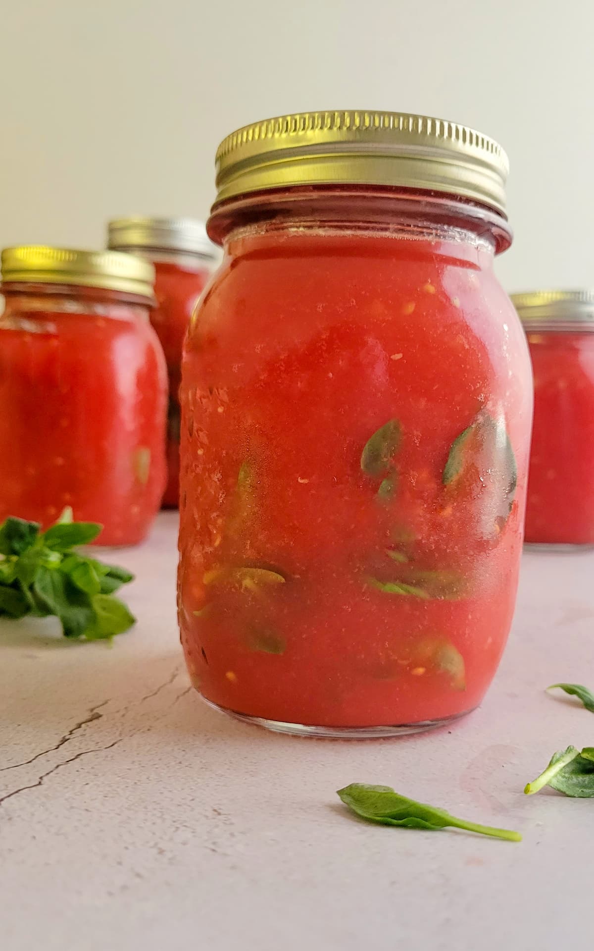 jars of tomato sauce with basil