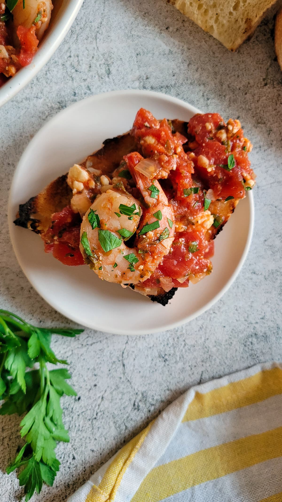 shrimp on toast with diced tomatoes and fresh herbs