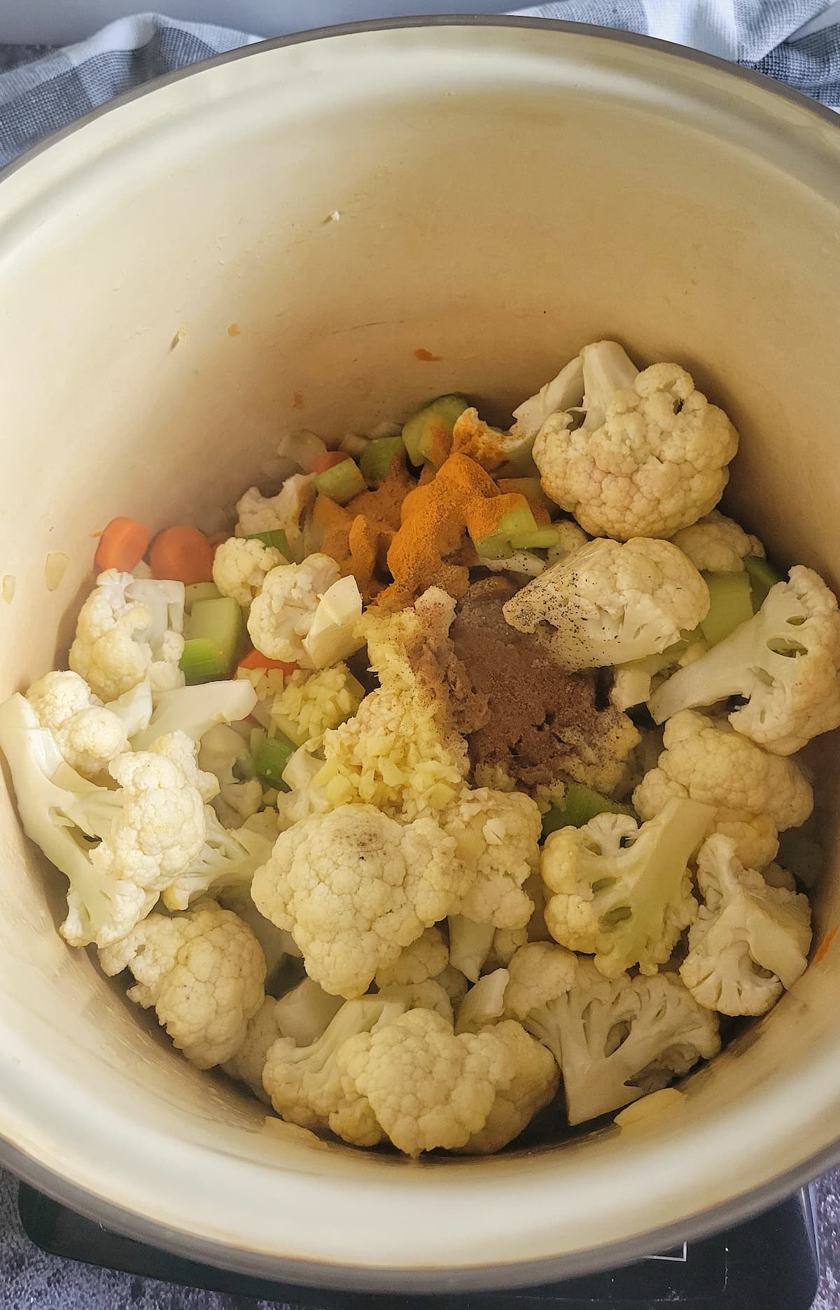 cauliflower, celery, carrots and spices in a large pot