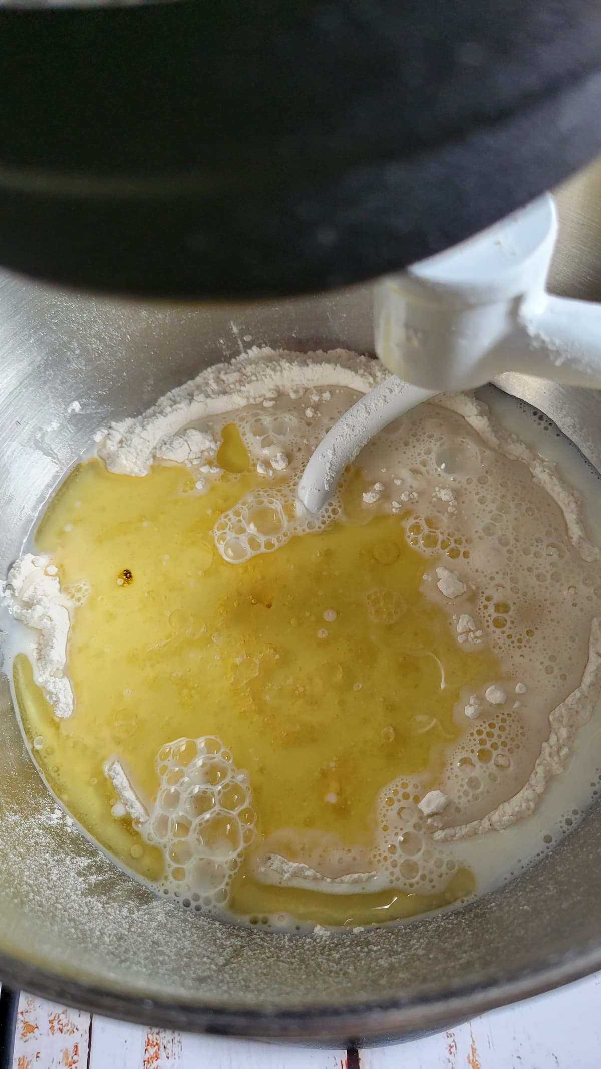 yellow liquid and flour in a kitchenaid mixer