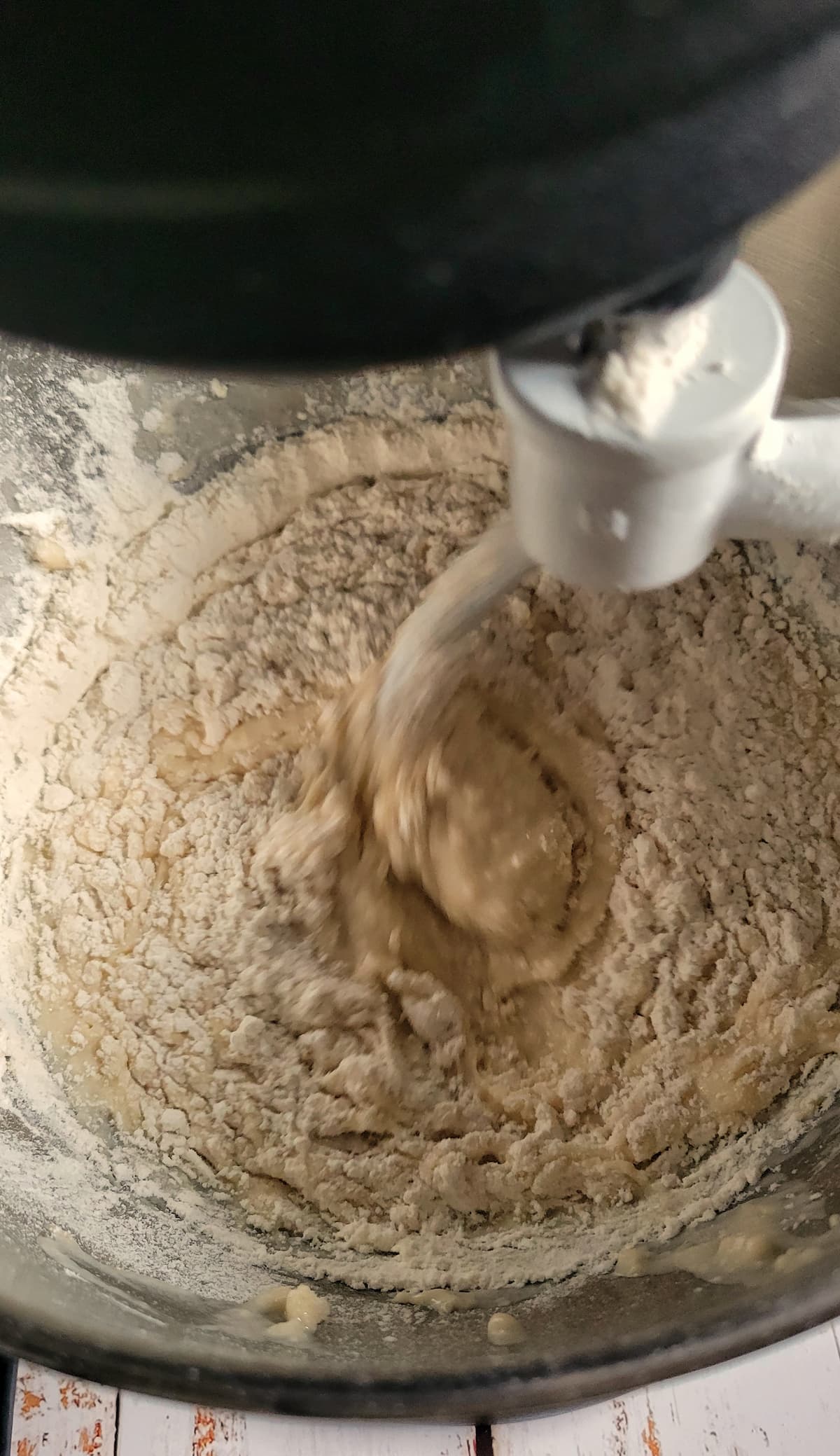 dough being mixed with a dough hook in a kitchenaid stand mixer