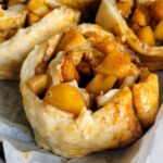 unbaked cinnamon and apple rolls on a tray
