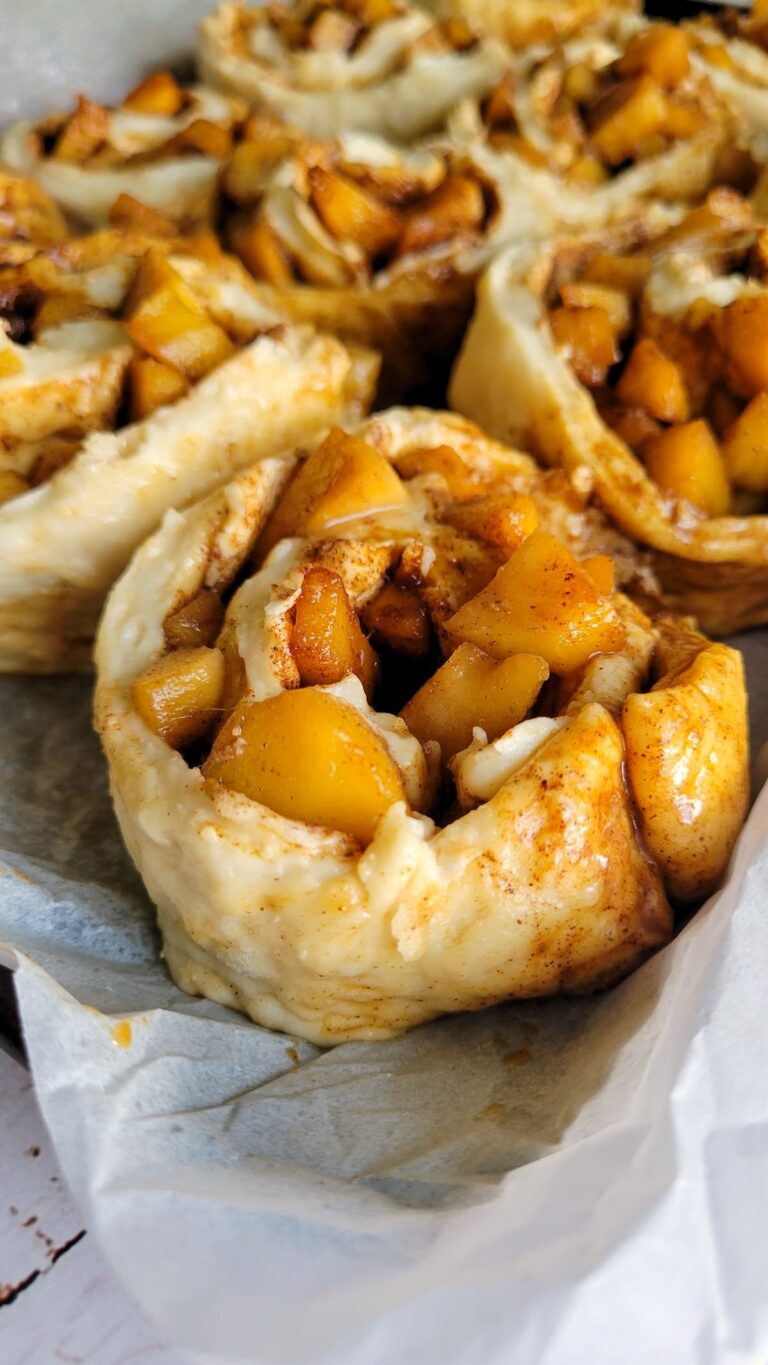 unbaked cinnamon and apple rolls on a tray