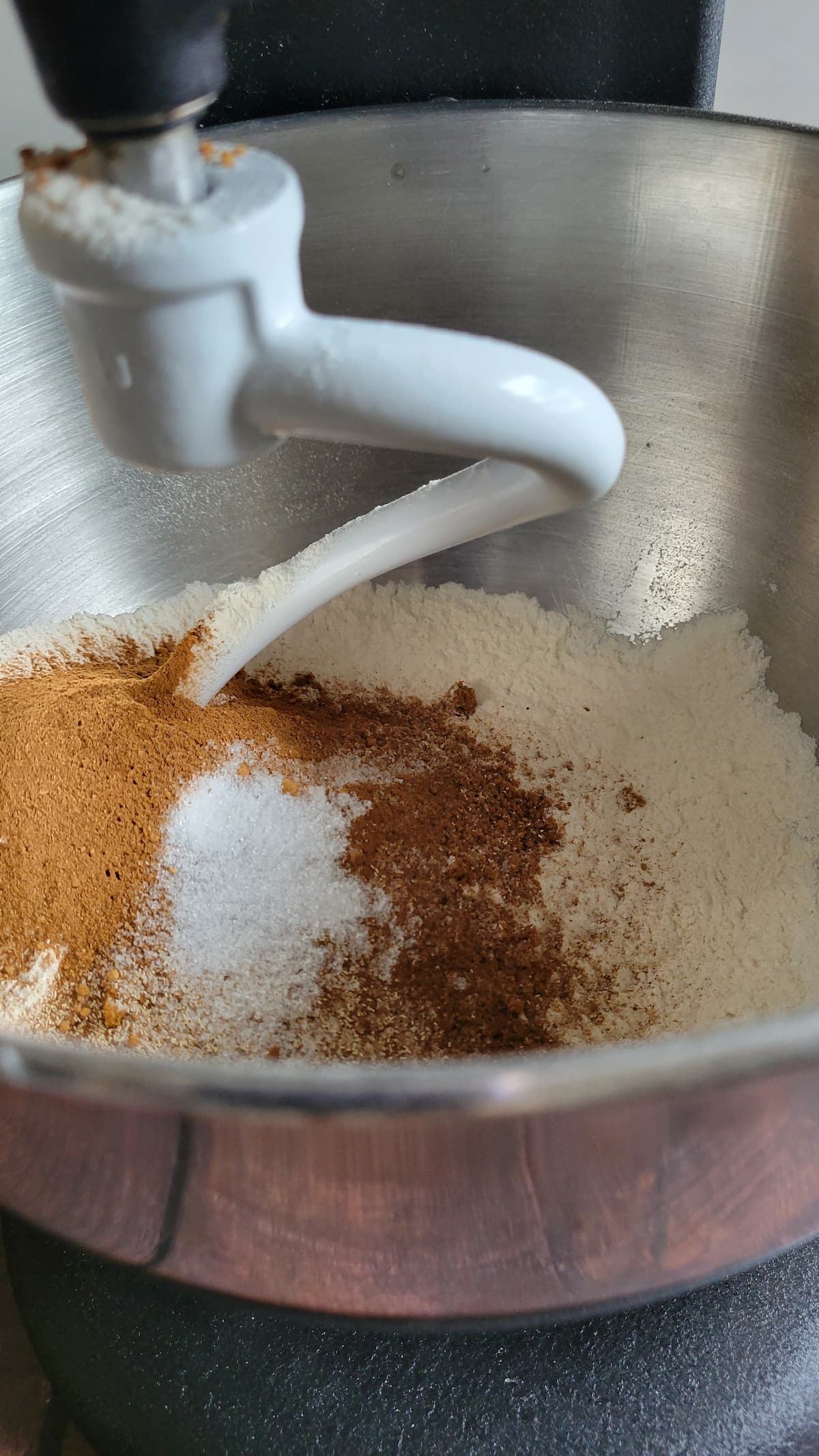 flour and spices in a mixing bowl with a dough hook