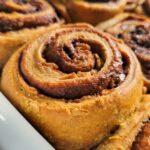 pumpkin cinnamon rolls in a tray