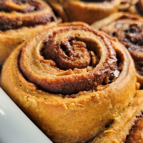 pumpkin cinnamon rolls in a tray